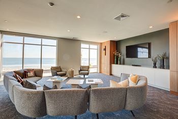 Clubroom with bar, lounge spaces, tv and patio access